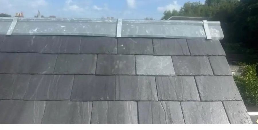 The same ridge re-dressed with new lead and matching slates fitted